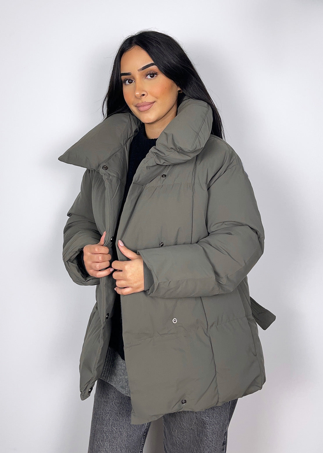 Modell trägt eine kurze Damen Steppjacke mit Taillengürtel – NAHA Fashion