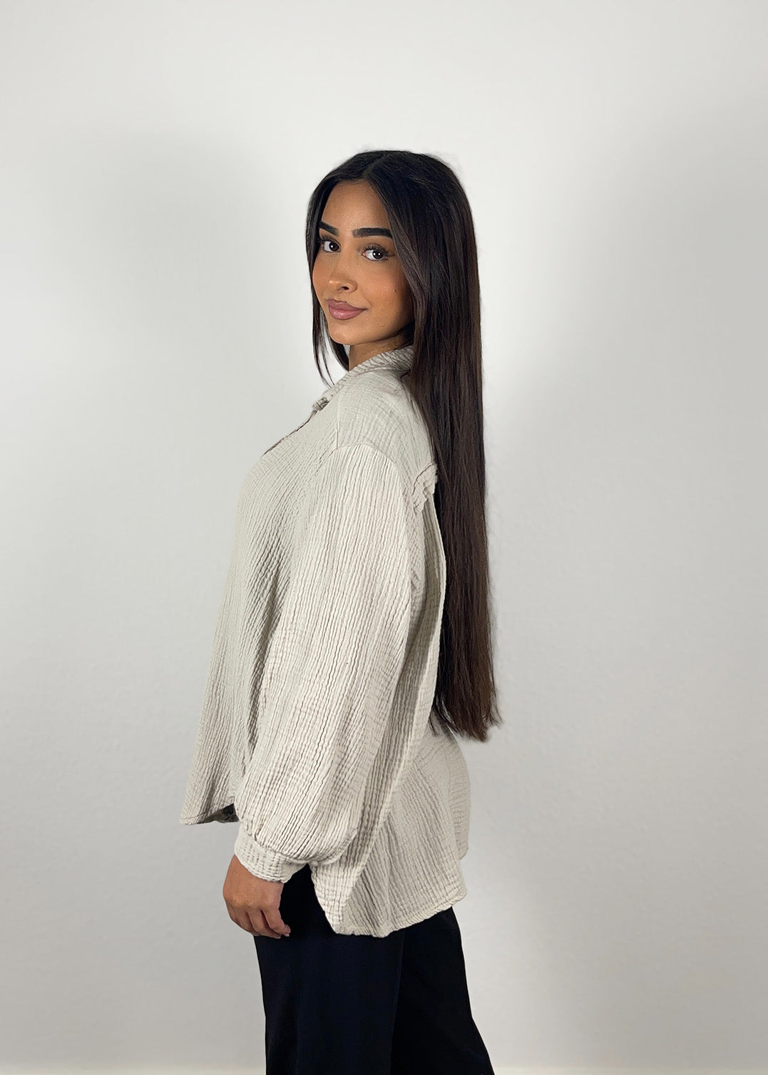 Frau trägt beige Musselin-Bluse aus Baumwolle – luftiger, natürlicher Sommerlook von NAHA