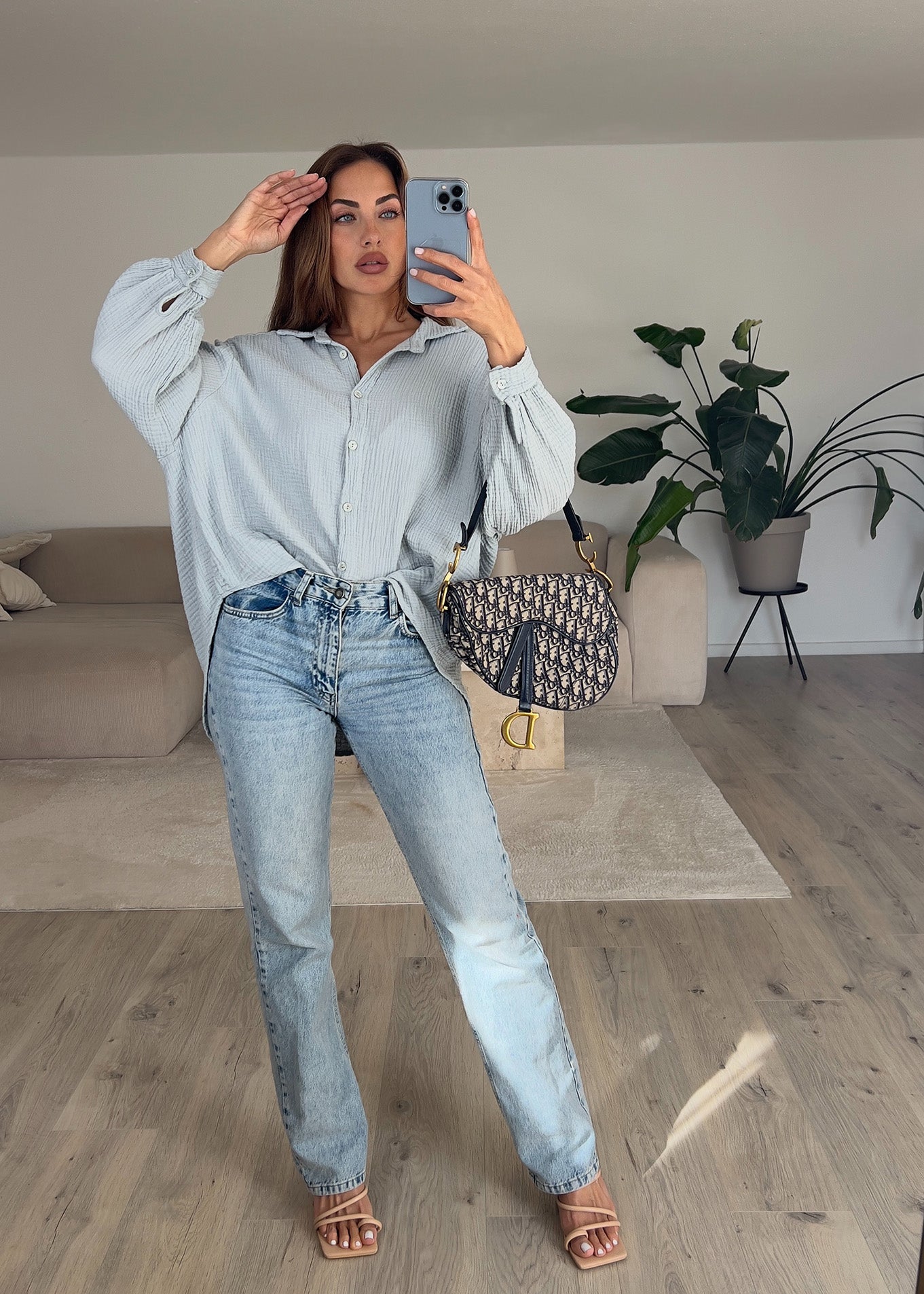 Frau trägt hellgraue Musselin-Bluse aus Baumwolle – moderner, cleaner Look von NAHA