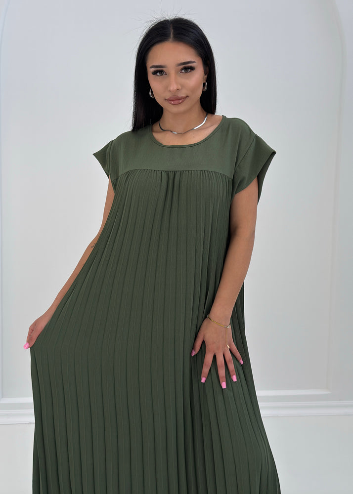 Frau trägt plissiertes Maxikleid in Khaki mit Rundhalsausschnitt
