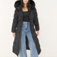 Schwarzer Steppmantel offen getragen zu schwarzem Top und Wide-Leg-Jeans